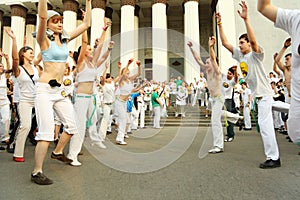 Men and girls dance on real capoeira performance