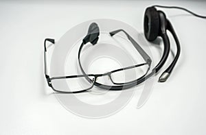 men glasses with headset on office desk