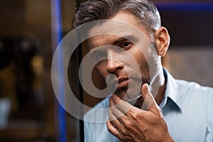 Men Grooming. Handsome Man With Beard Touching Face. Skin Care