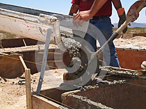 Men Guiding Cement with Shovel - Horizontal