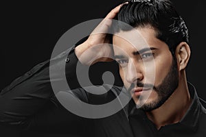 Men Hair Beauty. Handsome Male Model Touching Healthy Hair