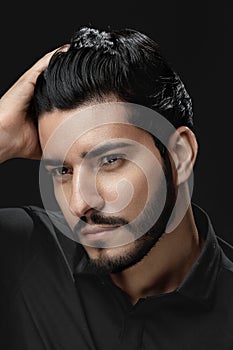 Men Hair Beauty. Handsome Male Model Touching Healthy Hair