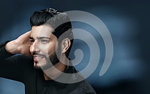 Men Hair Care. Handsome Man With Beard Touching Healthy Hair