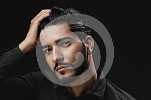 Men Hair Care. Man With Beard, Beauty Face Touching Black Hair