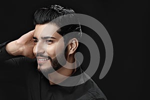 Men Hair Care. Man With Beard Touching Healthy Black Hair