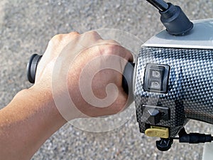 Men hand holding motorcycle handlebar