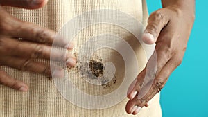 men hand holding shirt, showing making stain