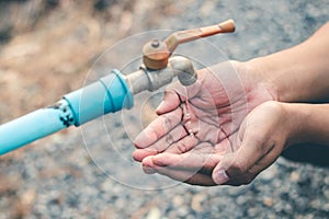 Men hand are waiting to drink water in the water shortage