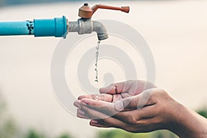 Men hand are waiting to drink water in the water shortage