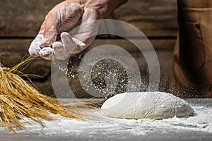 Men hands with flour splash. Cooking bread