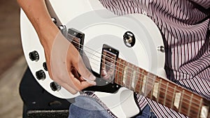 Men hands guitarist playing guitar outdoor. close-up