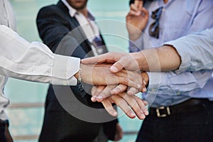 Men hands holding together in gesture of unity