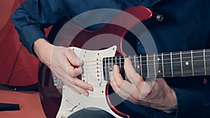 Men hands play the electric guitar photo