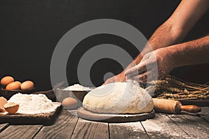 Men hands sprinkle dough flour close up