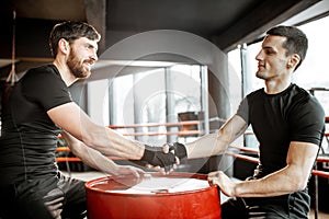 Men handshaking before fighting
