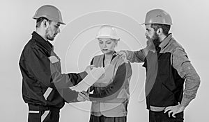 Men in hard hats, uniform and woman. Teamwork problems