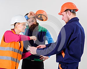 Men in hard hats and uniform and young woman.