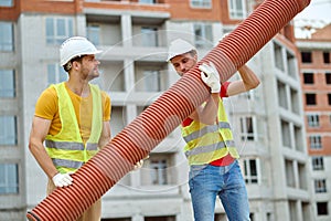 Men in hardhats and cotton gloves installing the sewer line