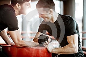 Men having arm wrestling in the gym