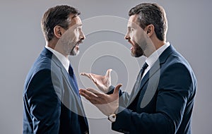 men having conflict. threatening business reputation. rival company threatening. businessmen threaten business men