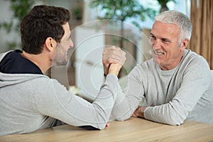 men having friendly arm wrestle photo