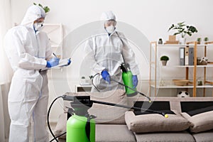 Men in hazmat suits cleaning home, epidemic