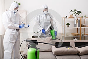Men in hazmat suits cleaning home, epidemic photo