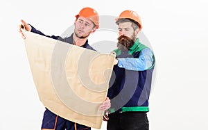 Men in helmets with blueprint on white background.