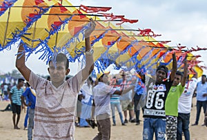 Men hold a Japanese kite on Negombo beach in Sri Lanka.