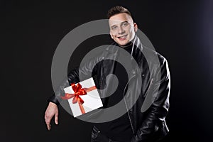 Men holding gift box for 14 February, holiday and christmas concept. Isolated over black background