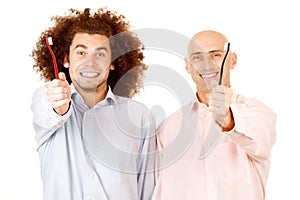 Men holding toothbrushes photo