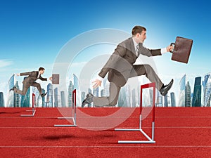 Men hopping over treadmill barrier with city