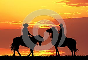 Men on horses at sunset