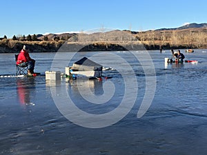 Men ice fishing on blue ice under blue sky 3.