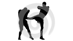 Men kickboxers train punches and kicks. Silhouette