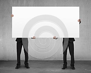 Men lifting blank board