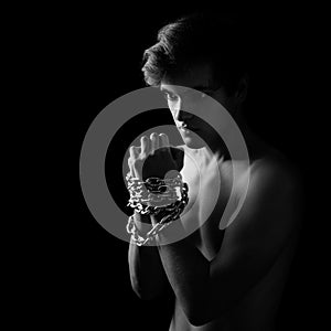 Men locked in metal chain on black background