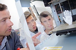 Men looking at artificial hand