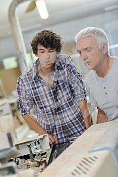 men looking at machine