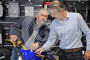 Men looking at motorcycle speedometer