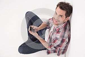 Men looking up. Top view of cheerful young men holding a mobile