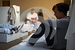 Men Lying On Beds In Homeless Shelter