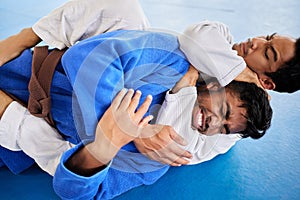 Men, martial arts and karate choke hold in dojo to practice fighting skill. Training, taekwondo and fitness class for