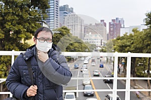 Men in medical mask with sore throat