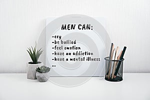 Men Mental Health Care Concept. Letterboard with Mental Health quote Men can cry on table at home.