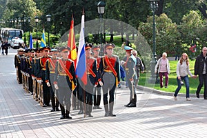 Men in military uniform stand holding flags.
