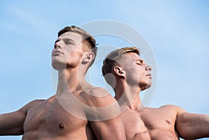 Men muscular chest naked torso sky background. Men muscular athlete bodybuilder relaxing lean each other. Masculinity