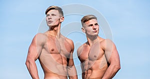 Men muscular chest naked torso stand sky background. Strong muscles emphasize masculinity sexuality. Bodybuilder shape