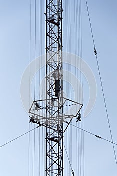 Men painting the highest Czech construction radio transmitter tower Liblice