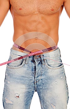 Men with perfect abs measuring his waist